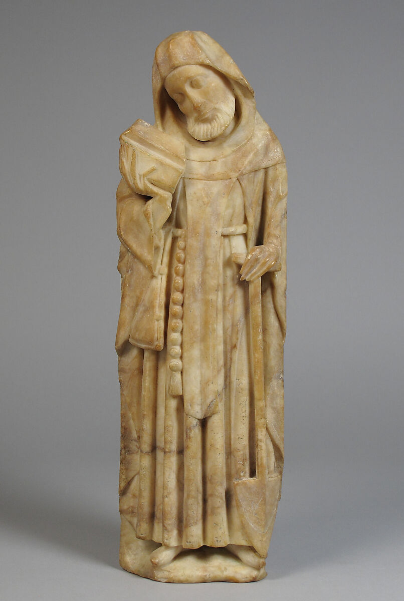 An alabaster statue of St. Fiacre holding a shovel in his left hand. 