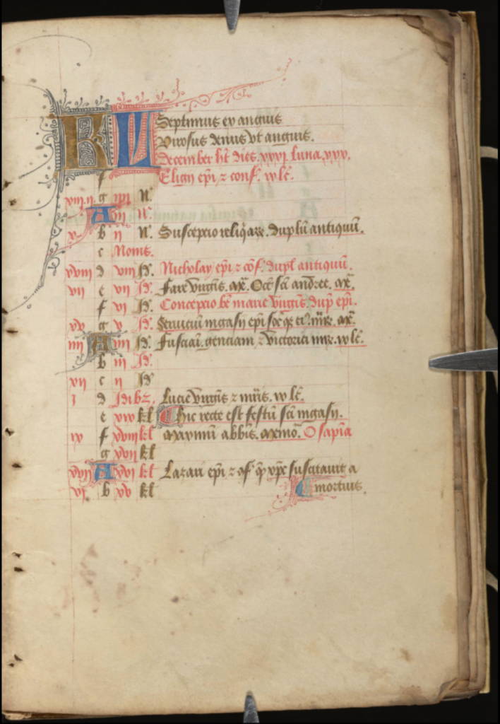 a medieval calendar page with lines written in red and black